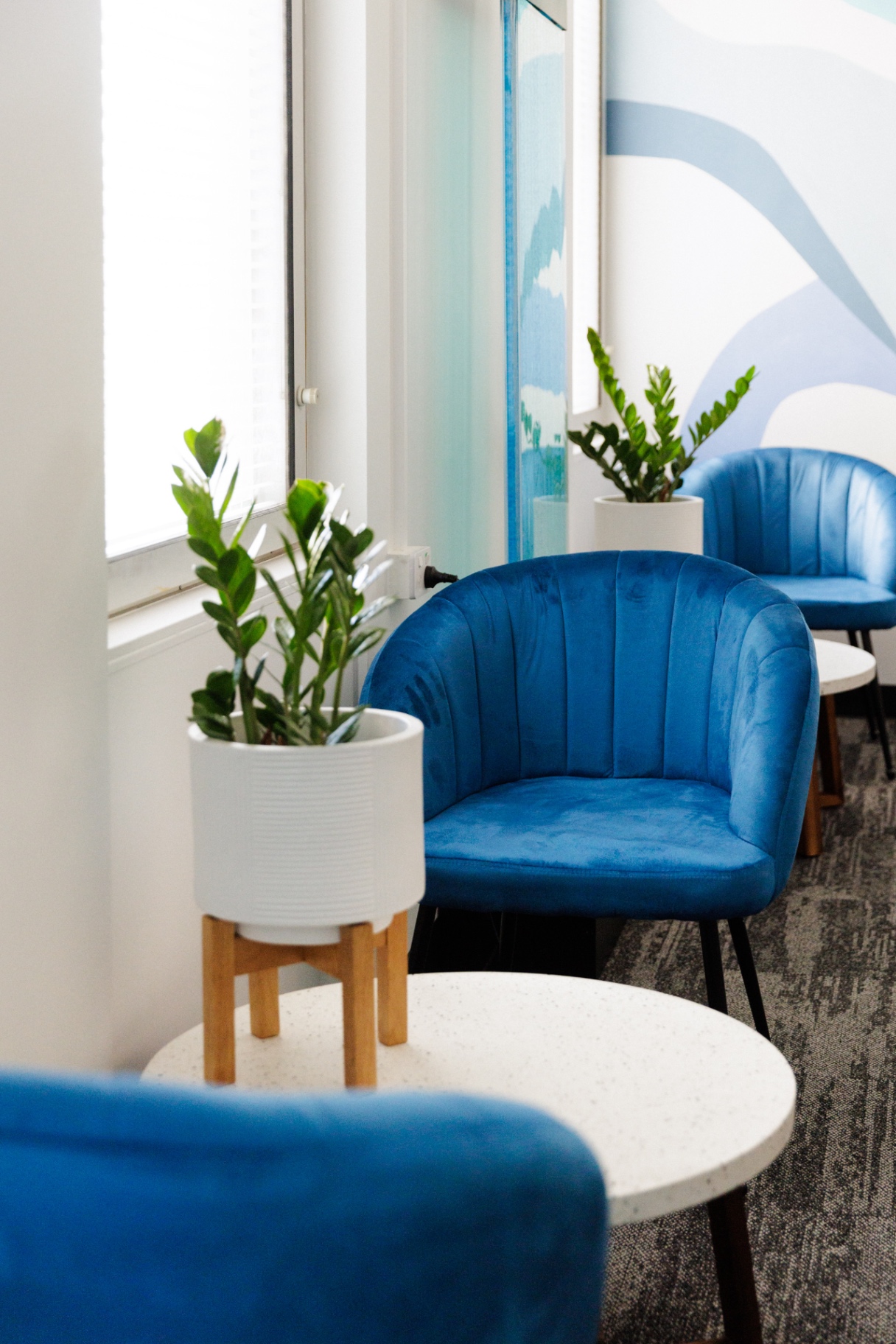 Lounge seating area with blue velvet chairs